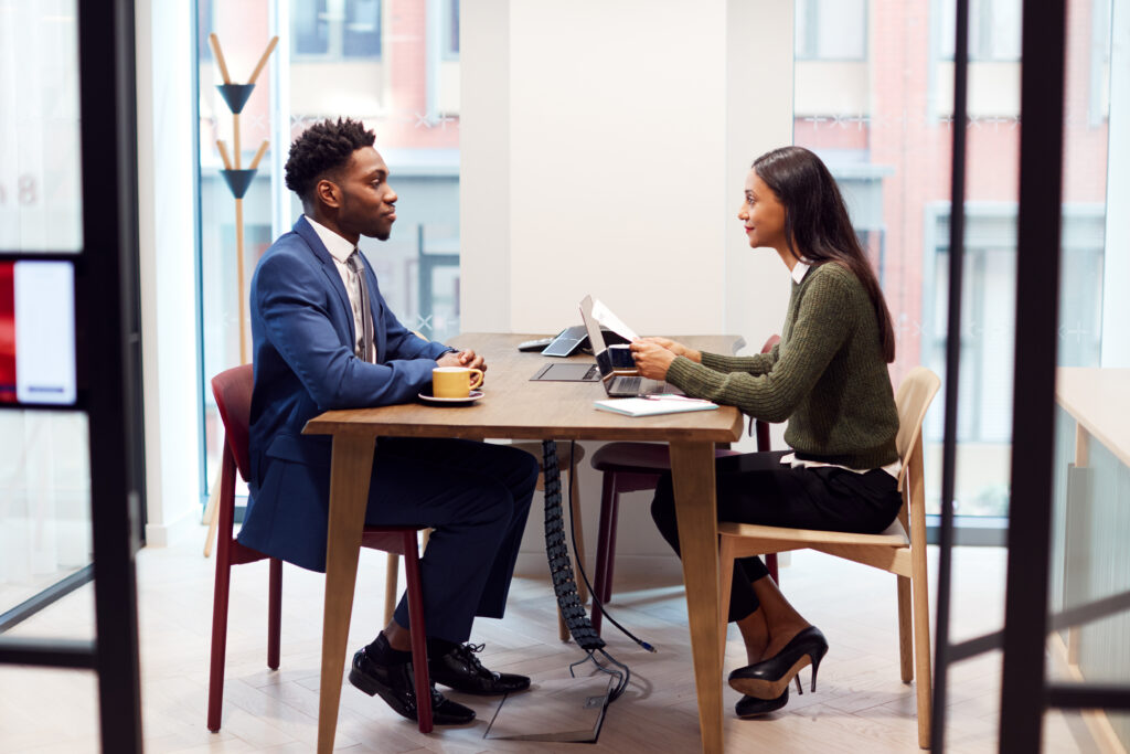 Two professionals practicing answers during a mock interview