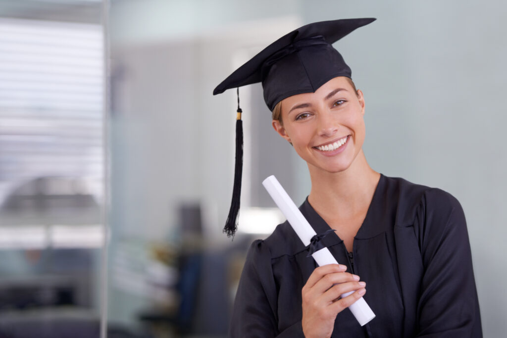 A smiling female graduate holding a diploma, representing new graduate employment opportunities and a bright future ahead.